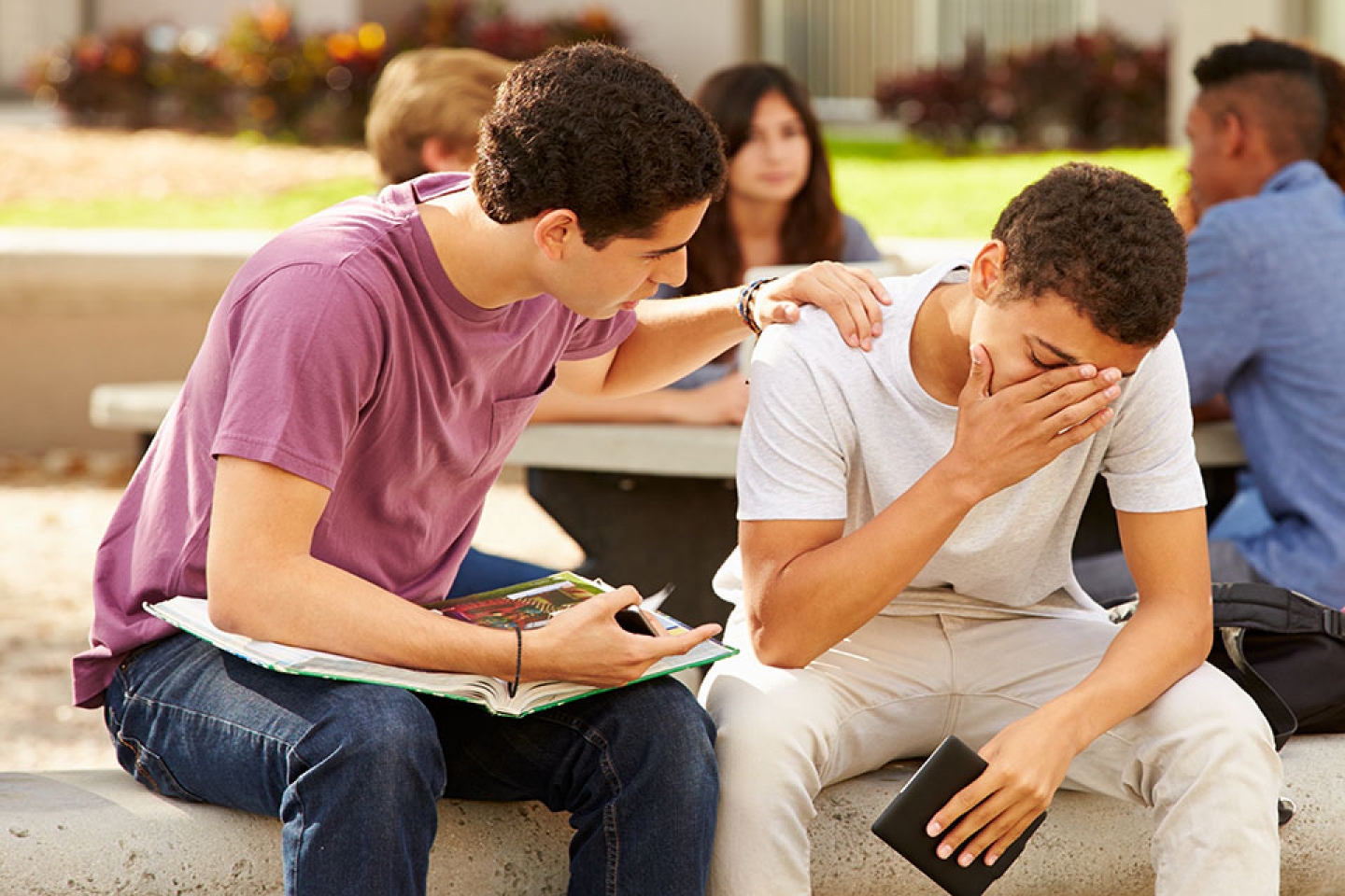 Teen being comforted by friend